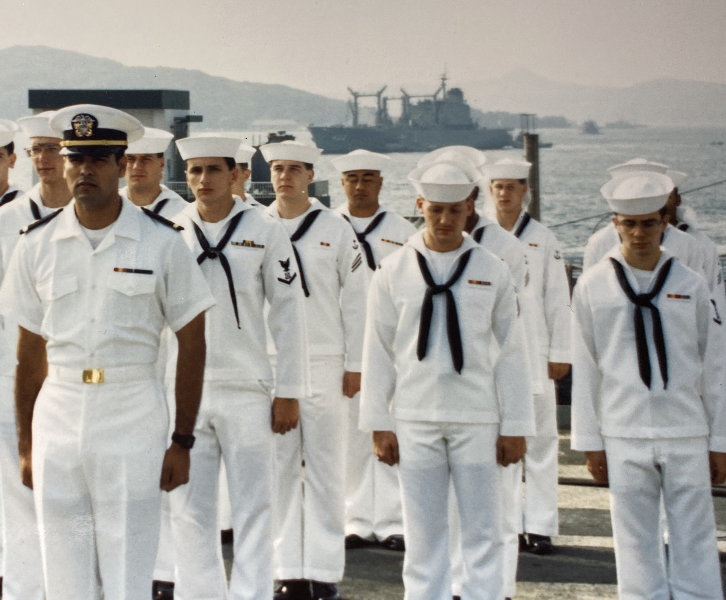 Gil Hernandez serving as a U.S. Navy officer with sailors in formation